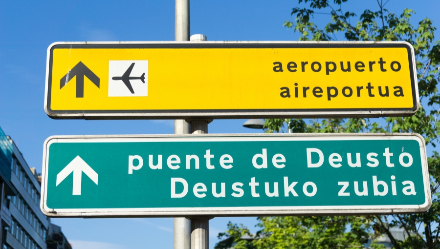 Street sign showing multiple languages