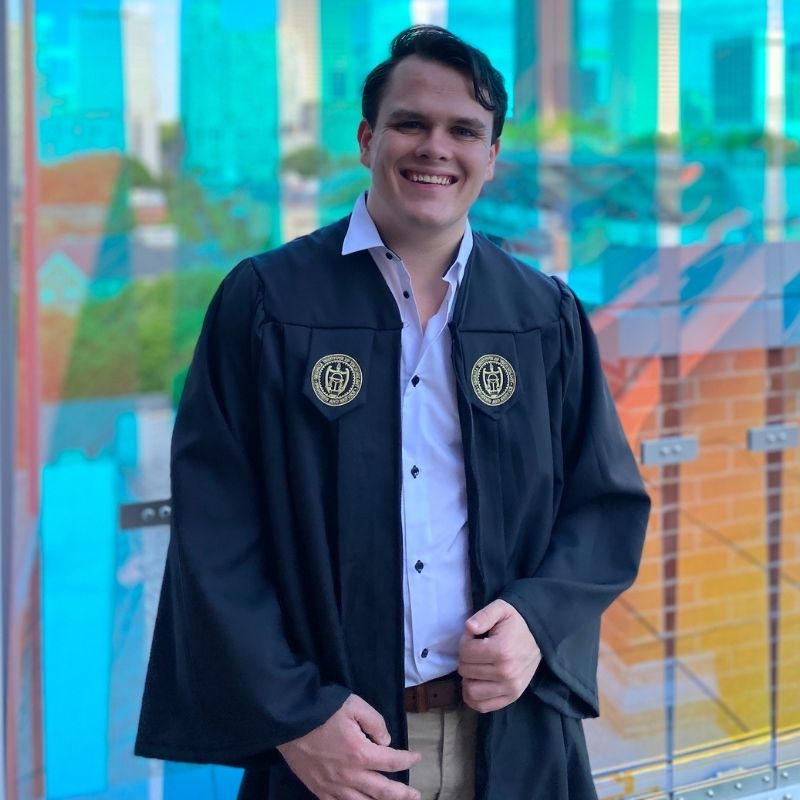 Photo of Parker Reed in graduation Regalia on the Crosland Tower rooftop.